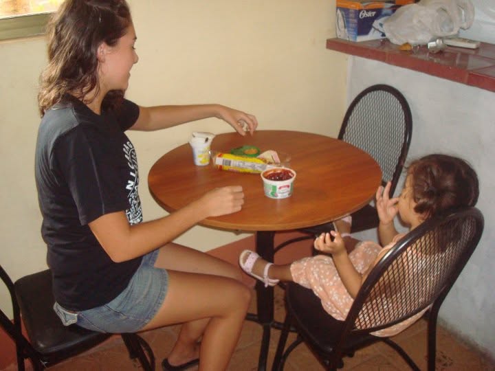 Nanny sharing a snack with a young child